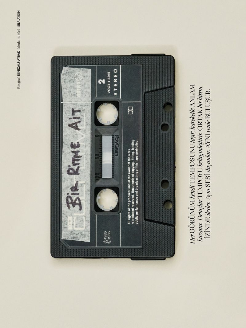 An overhead shot features a black cassette tape with handwritten text, set against a cream background with additional typography.