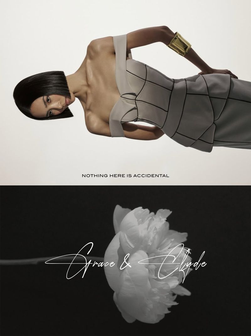 A woman with short black hair wearing an elegant white dress and gold cuff poses on a white background above a close-up flower.