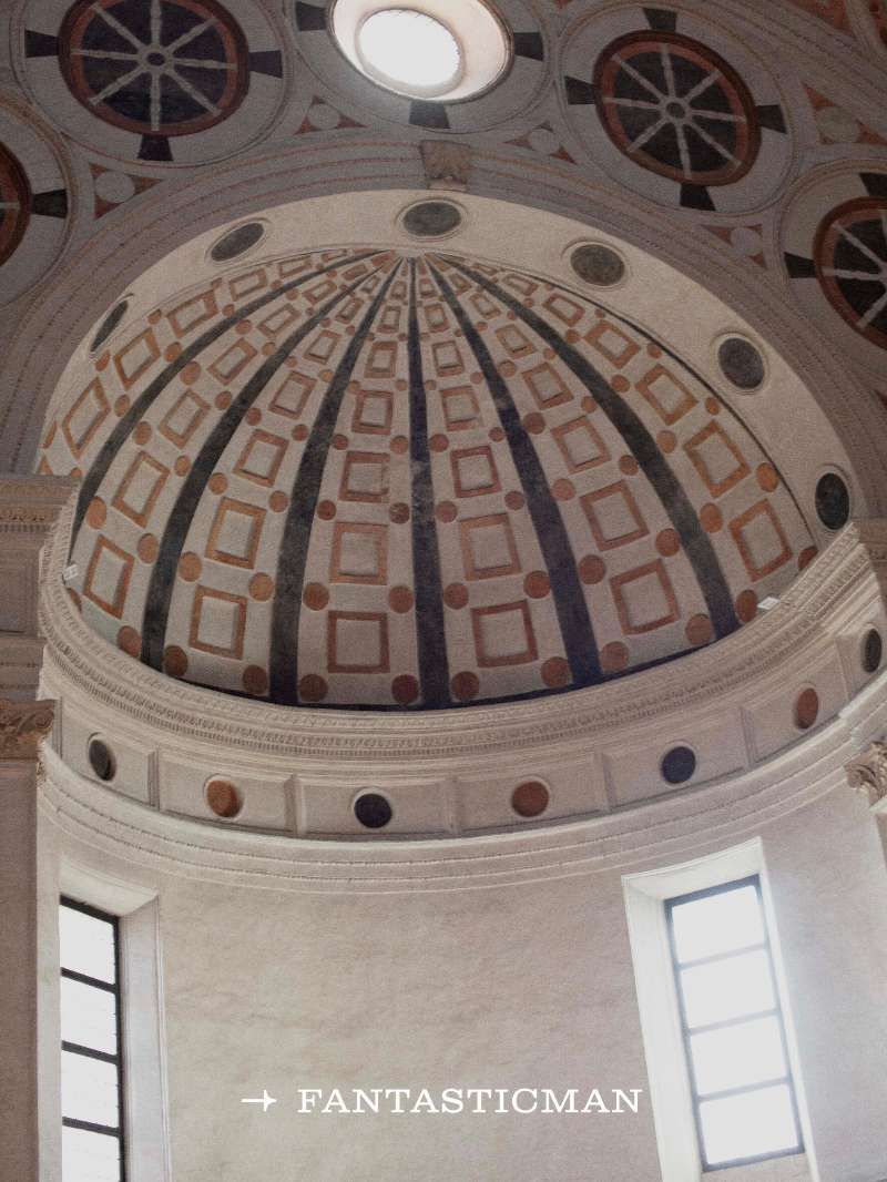 Ornate architectural dome with geometric patterns and a skylight, interior view showcasing detailed design elements, indoor space, soft lighting.