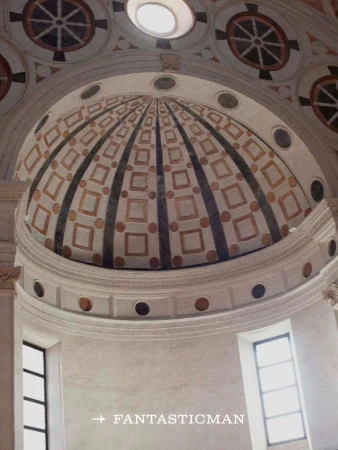 Ornate architectural dome with geometric patterns and a skylight, interior view showcasing detailed design elements, indoor space, soft lighting.