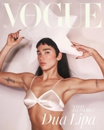 Dua Lipa wearing a white star hat and white satin bra for British Vogue July 2025 magazine cover photography by David Sims.