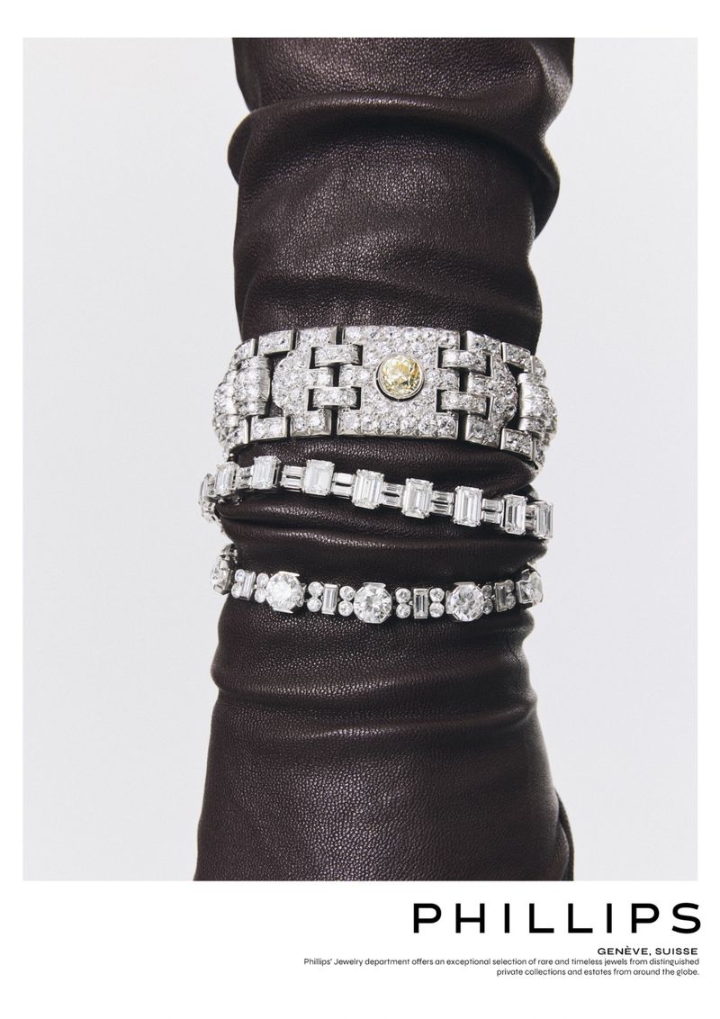 An arm with a brown leather glove adorned with three diamond bracelets stacked on top of each other on a white background.
