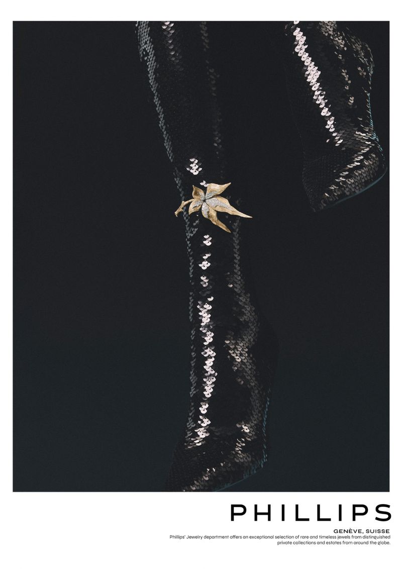 Sequin-covered garment with a floral brooch pinned on it, set against a dark background, emphasizes texture and elegance.