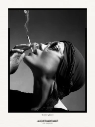 Black and white portrait of a woman wearing transparent glasses and a dark headwrap, holding a lit cigarette with rising smoke.