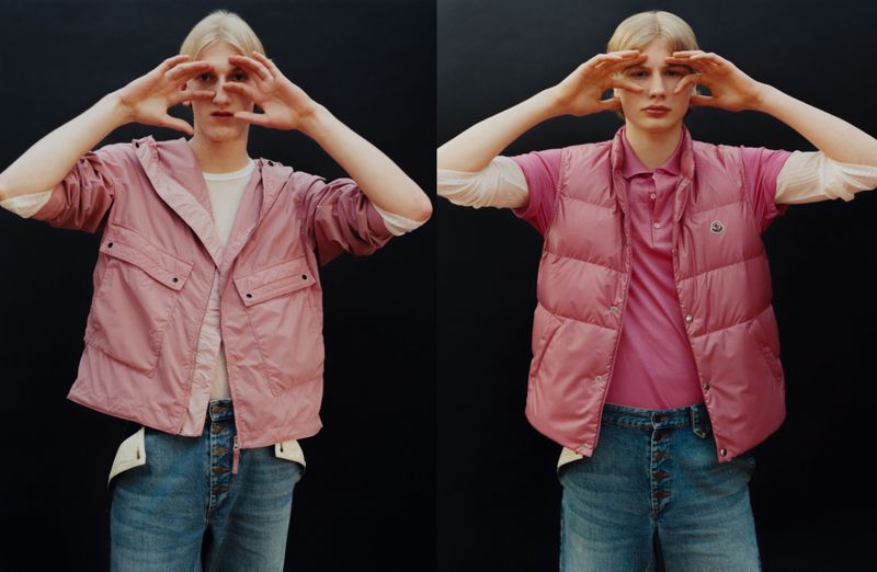 Two images of a light-skinned male model with blonde hair wearing a pink hooded jacket and a pink vest and blue jeans making a frame with his hands.