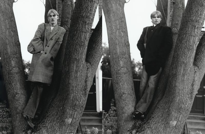 Black and white editorial diptych of model Orlando Straub leaning against a large tree trunk wearing tailored menswear coats.