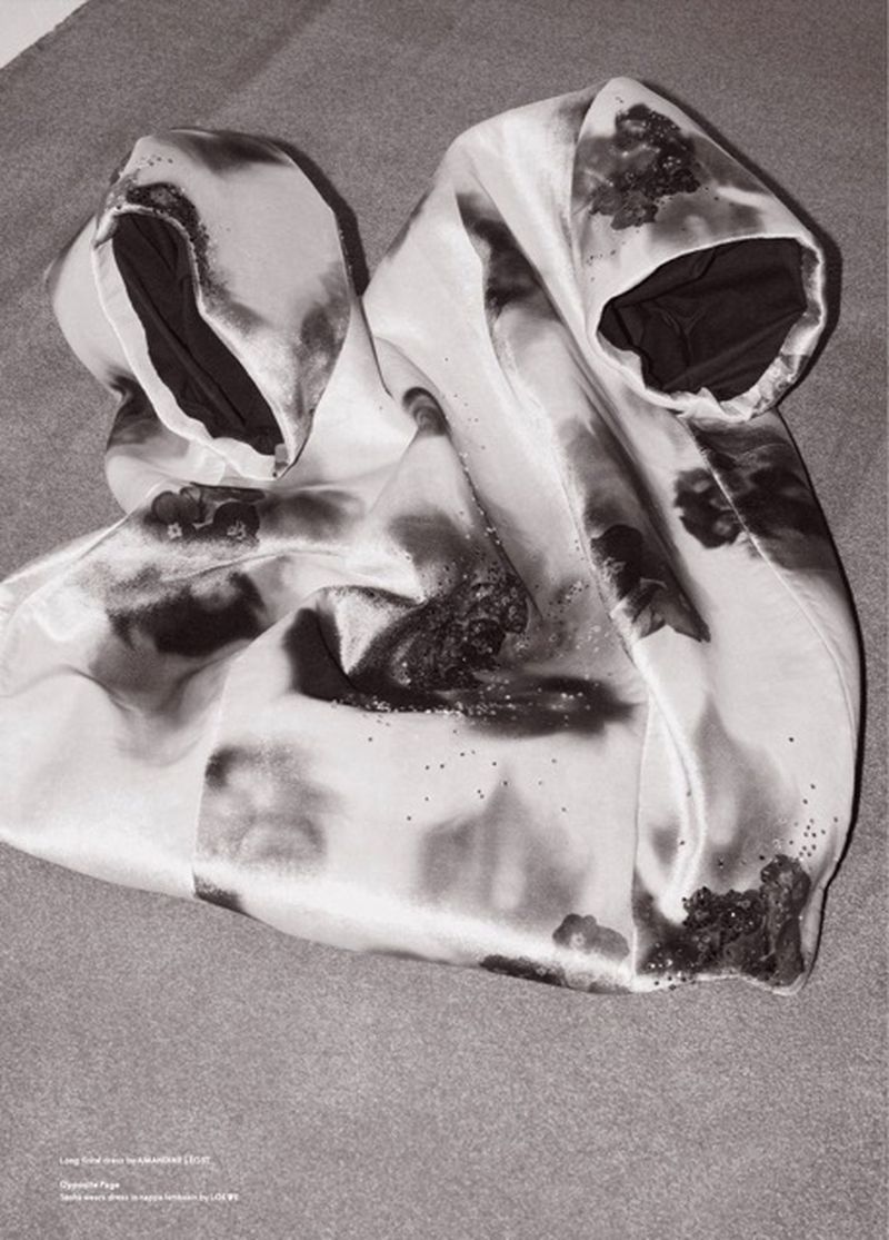 Monochrome photo of a garment with floral pattern on a gray textile, showcasing a still life composition and textile design.