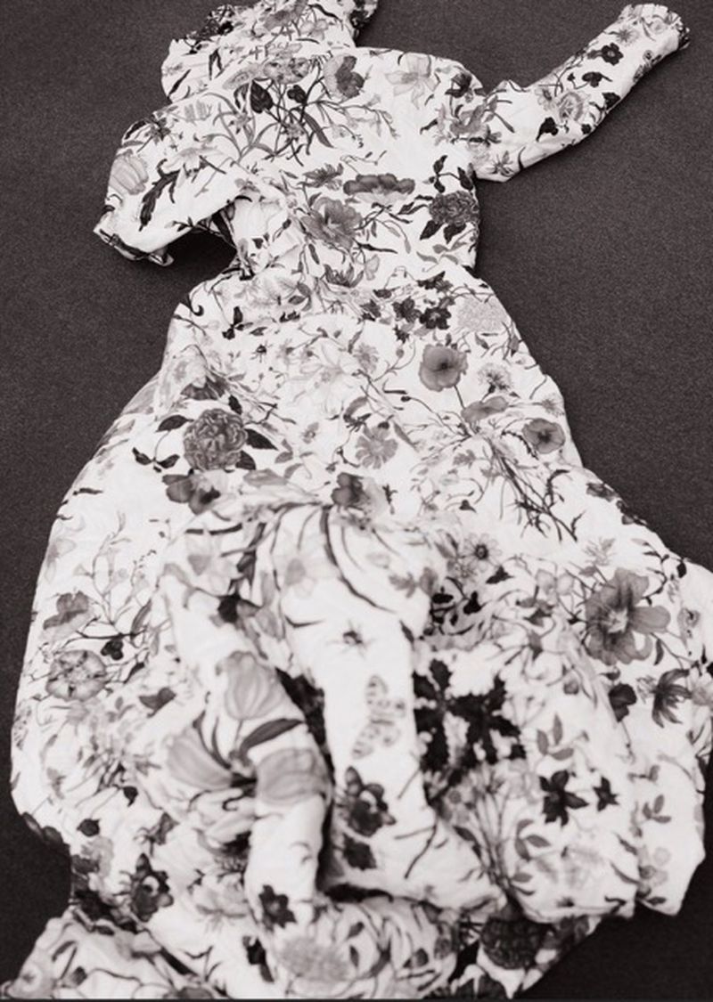Floral-patterned dress on a flat surface. Monochrome image showcases the garment's fabric and design. Ideal for fashion or textile collections.