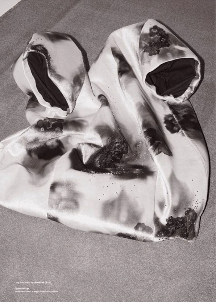 Draped silk garment with an abstract smoky black and white print laid on a neutral flat surface.
