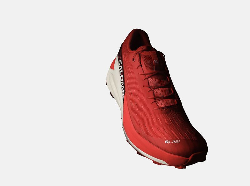 Studio shot of a red Salomon S/Lab trail running shoe featuring an innovative design and advanced traction for off-road adventures.