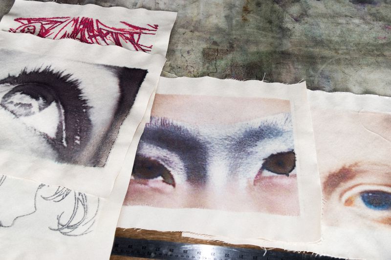 Several fabric swatches with detailed eye images, showcasing textile design, artistry, and creative fabric printing techniques.