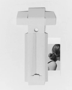 Unfolded white die-cut cardboard packaging structure layered over a black and white portrait print on a neutral paper background.