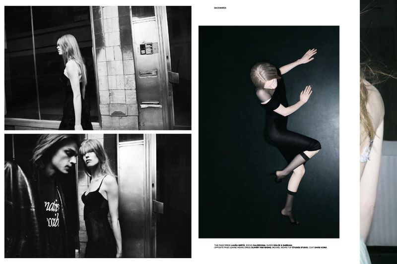 Black and white fashion editorial featuring two models in dark clothing, shot in an urban environment with stark lighting and minimalist style.