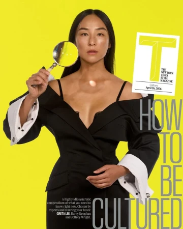 Magazine cover featuring Greta Lee, Asian woman in black suit, holding magnifying glass against yellow background with magazine text.