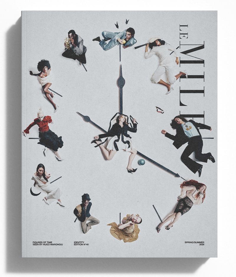 Fashion magazine cover featuring models posing around a clock face against a white background, with bold magazine title and fashion details.