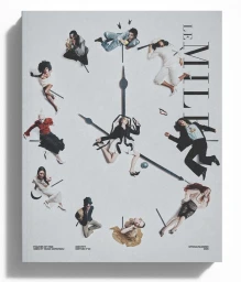 Magazine cover featuring fashion models arranged in a circle forming a clock face with black clock hands against an off-white background.