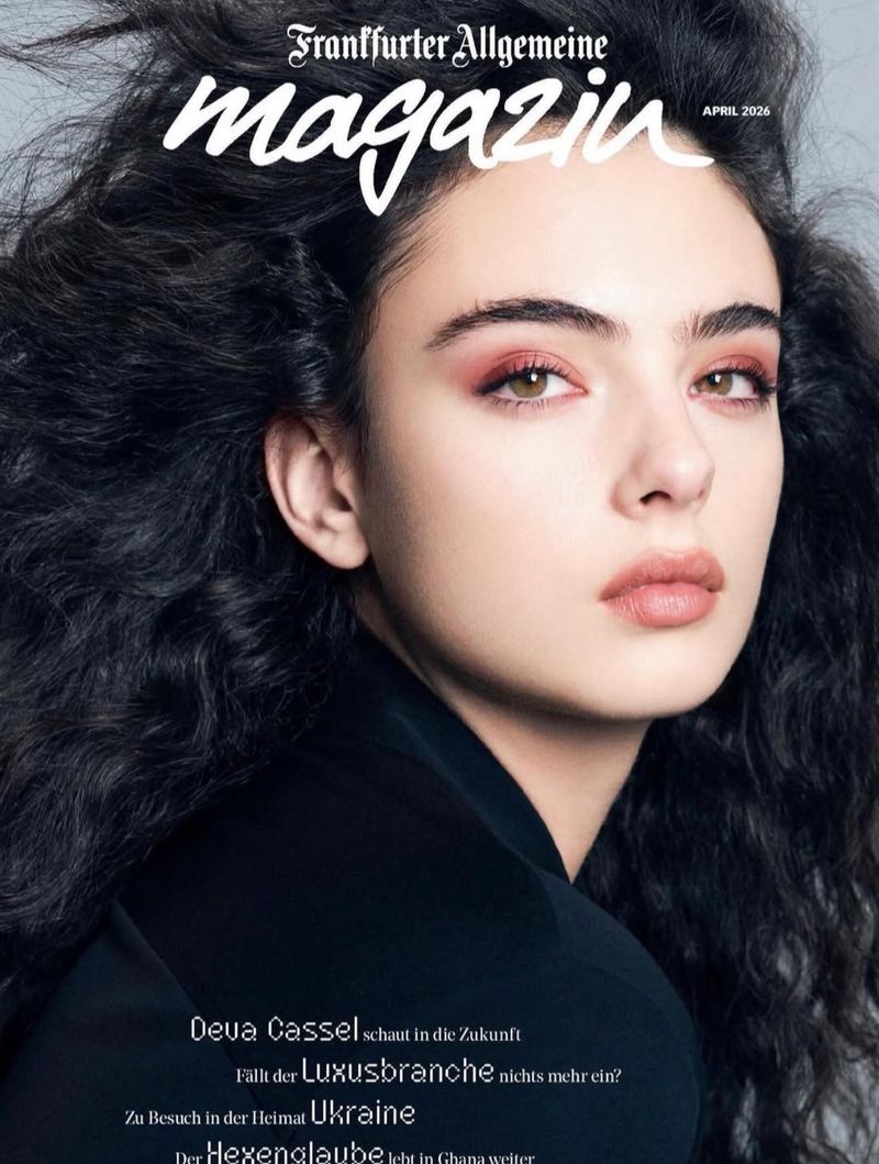 Magazine cover featuring a portrait of a young woman with dark, wavy hair, pink eye shadow, and glossy lips, along with magazine text.