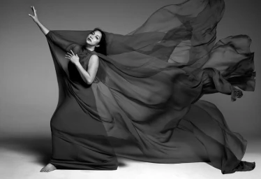 Model Anna Bayle in a flowing black gown with billowing fabric against a grey studio backdrop captured by Mark Seliger for Vogue Philippines.