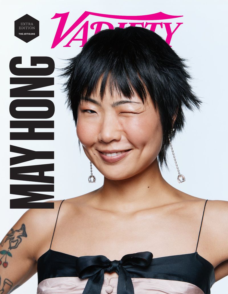 Variety magazine cover featuring May Hong, winking at the camera, wearing black-and-light-pink dress with earrings, against white background.
