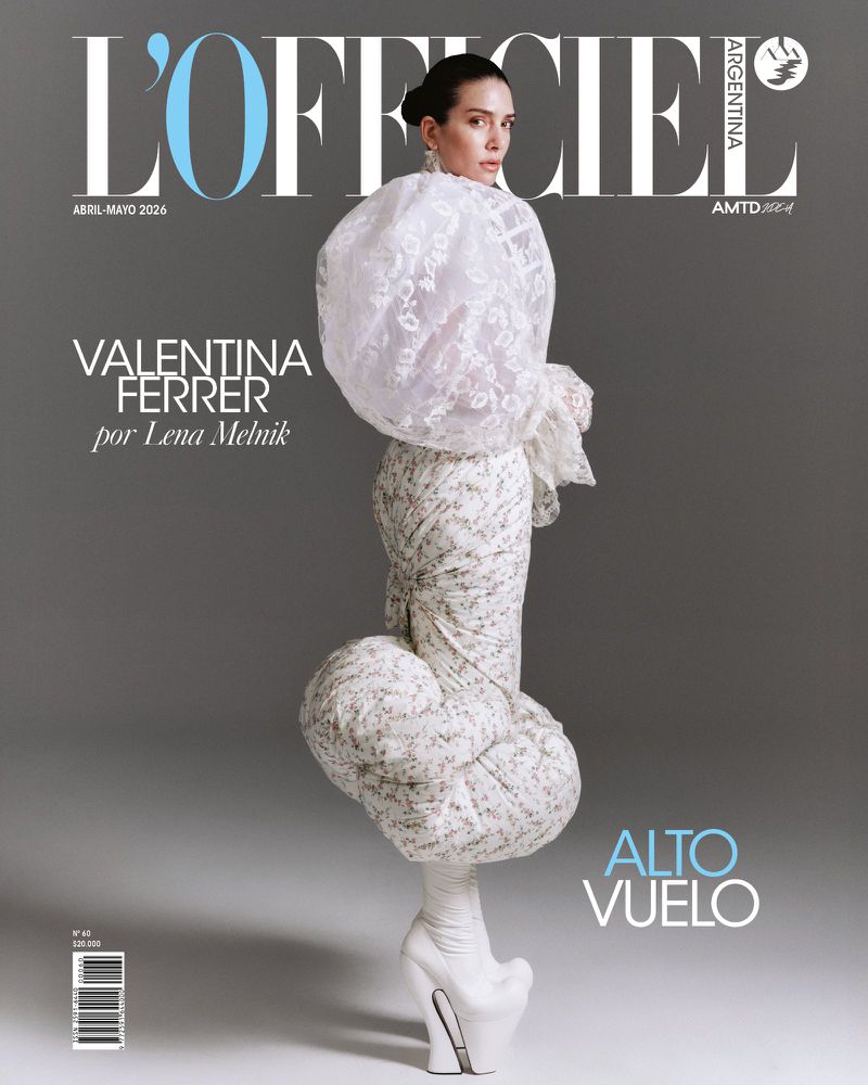 L'Officiel Argentina cover featuring a woman in a high-fashion white dress with a large, puffy, lacy top and extreme platform shoes.