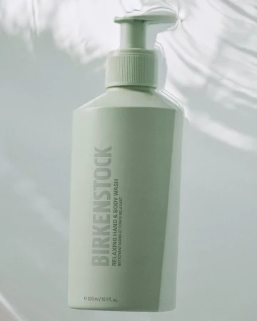 Birkenstock hand and body wash in a light green bottle with pump dispenser, set against a soft, bright backdrop.