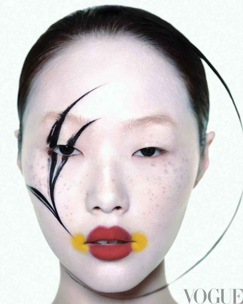 Close-up portrait of model Peng Chang with bold black face paint and red lips for Vogue China Luminous Whispers editorial