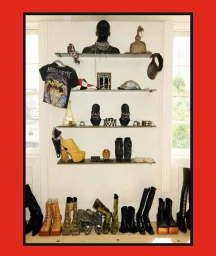 Shelves and floor displaying an eclectic collection of designer boots, platform heels, jewelry, a band shirt, and a mannequin bust.