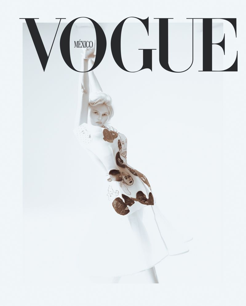 Model Elena Matei in an illustrative printed white dress posing with raised arms against a white background for Vogue Mexico.