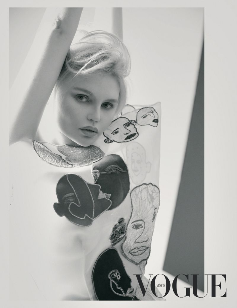 Elena Matei poses in an embroidered face top with her arm raised in a black and white editorial portrait for Vogue Mexico.