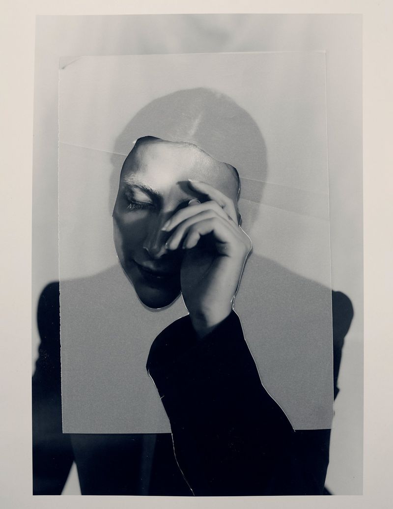 Monochrome layered collage portrait of Mason Alexander Park resting a hand on their temple against a white backdrop for Schön Magazine.
