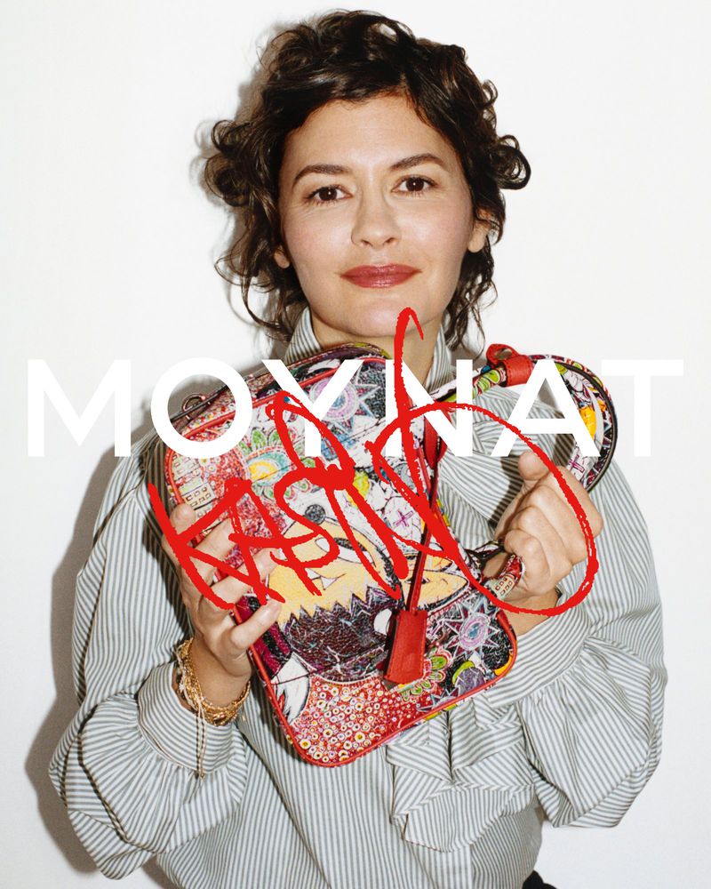 Audrey Tautou holding an illustrated Moynat handbag against a white background.