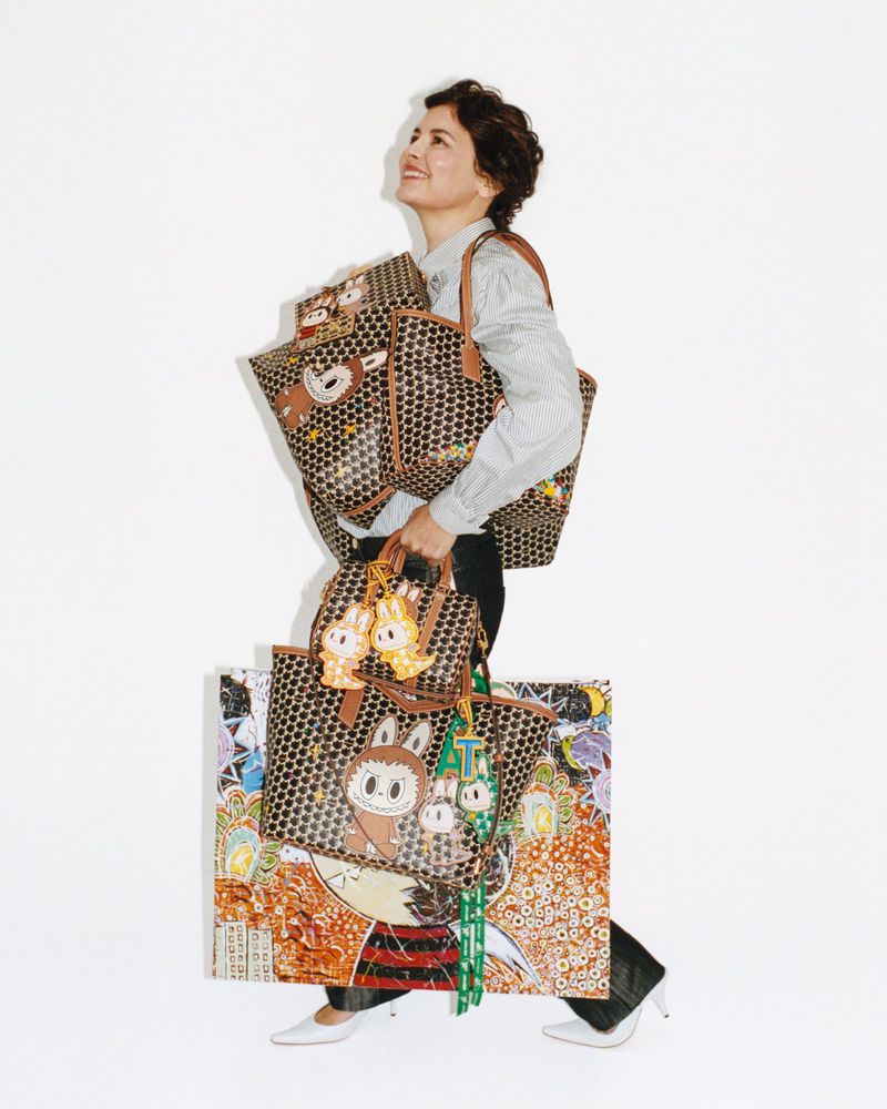 Audrey Tautou carrying multiple Moynat Kasing Lung collection patterned tote bags and charms against a white background.