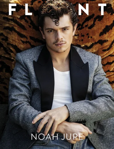 Noah Jupe wearing a grey blazer with black lapels over a white tank top for Flaunt Magazine cover.