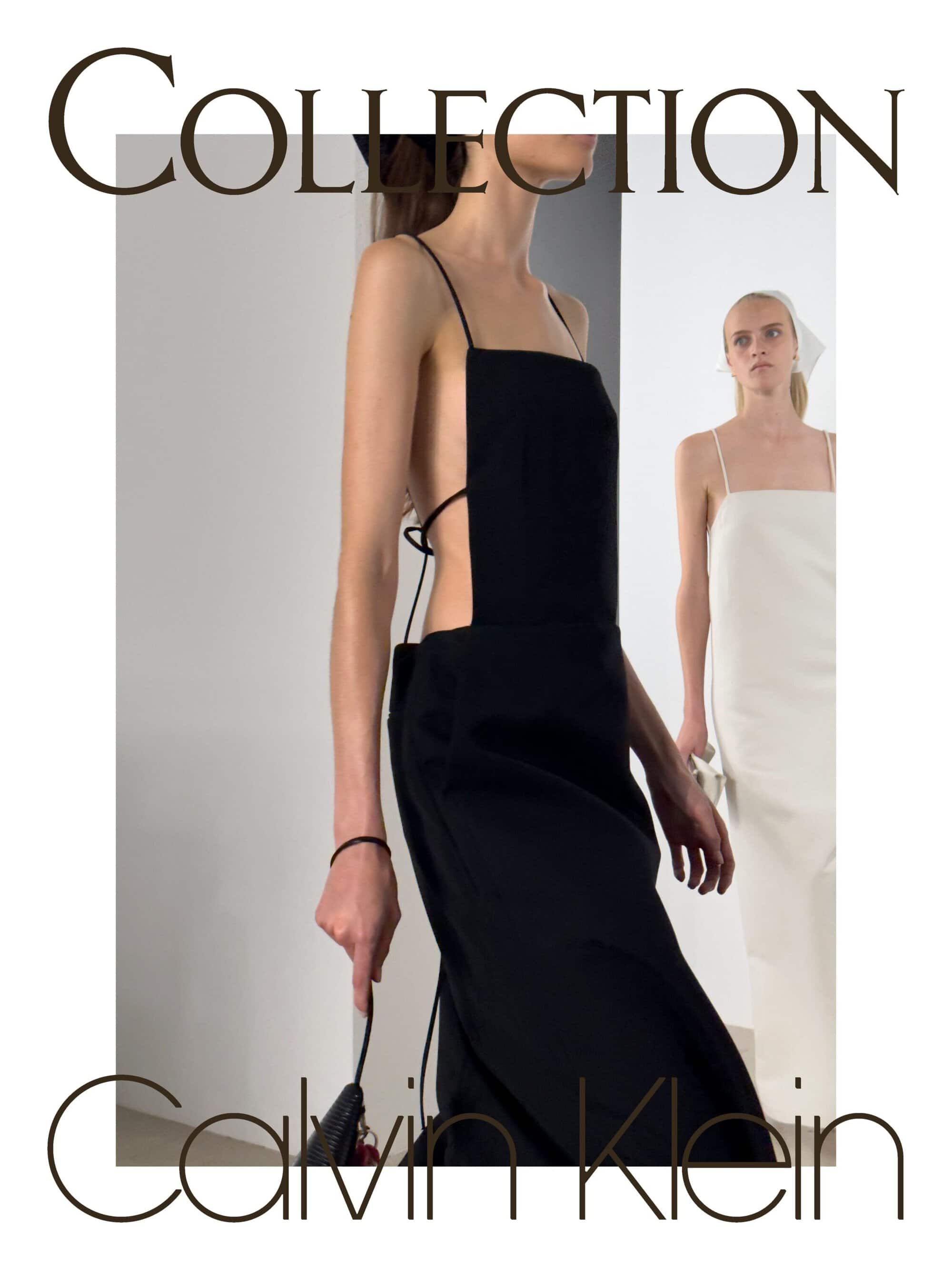 Model in a black backless dress walking past another model in a white dress against a minimalist grey and white background
