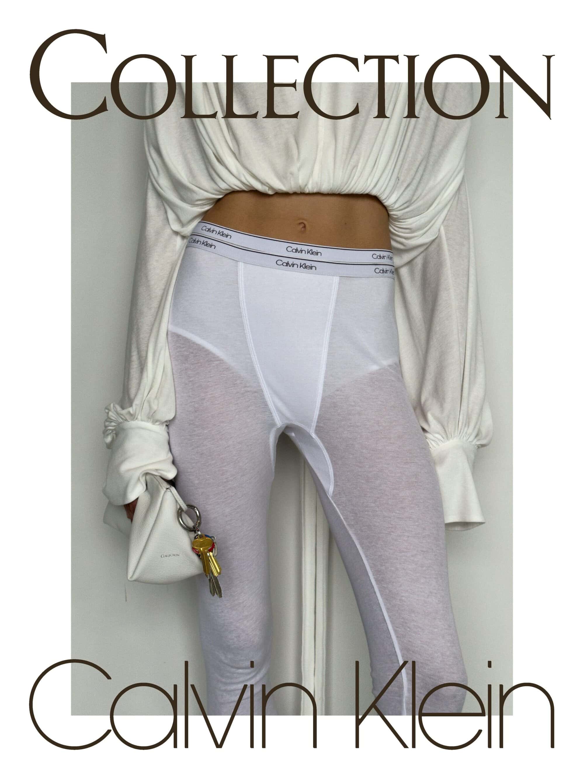 A model wearing sheer white Calvin Klein branded leggings and a gathered cream top, holding a small pouch with keys against a pale wall.