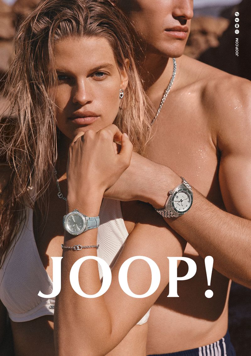 Kim Riekenberg and Gianluca Alessi posing close together wearing wristwatches and swimwear for Joop campaign.