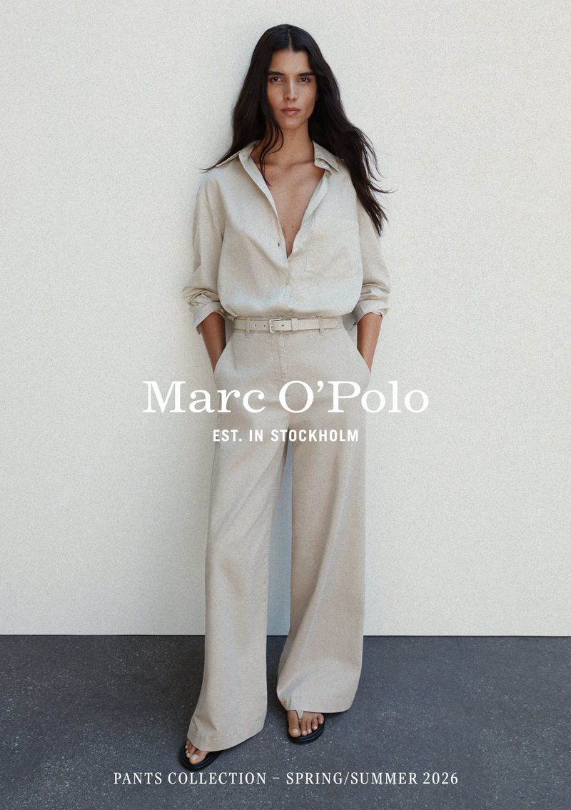 Model Paula Soares in a beige linen button-down shirt and matching wide-leg trousers for Marc O'Polo pants collection.