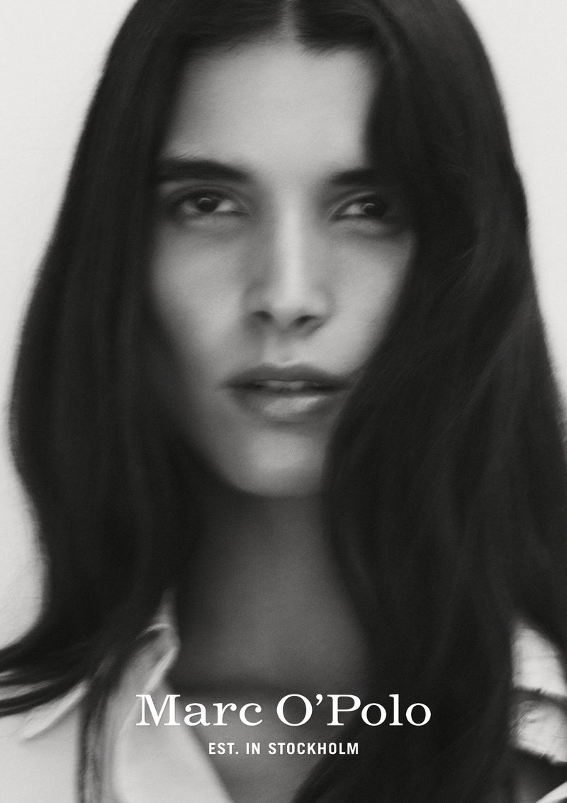Monochrome close-up portrait of model Paula Soares wearing a white collared shirt for Marc O'Polo.