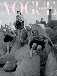 Model Liva Been posed across concrete tetrapods on a coastline for Vogue Greece, wearing a textured top and voluminous black skirt.