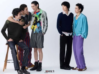 Five young Asian male models posing and interacting in eclectic designer menswear against a plain white studio backdrop.