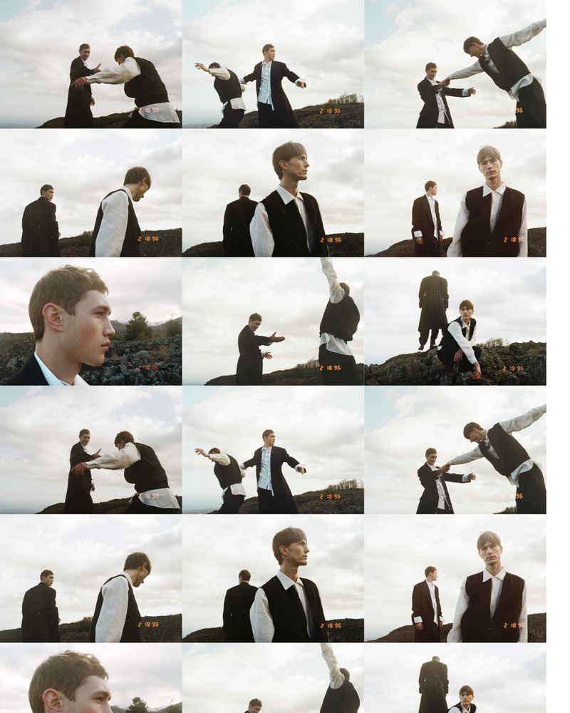 Two male models posing outdoors against a cloudy sky and rocky terrain for ICON Magazine Italy