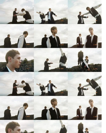 Two male models posing outdoors against a cloudy sky and rocky terrain for ICON Magazine Italy