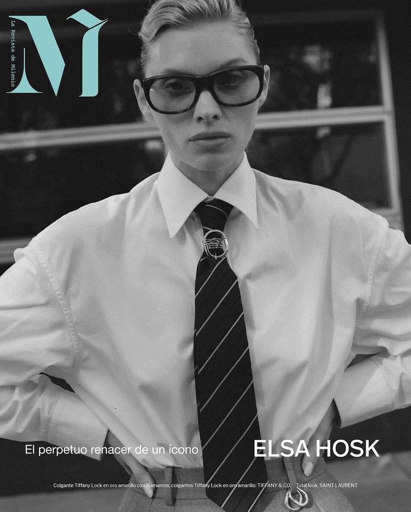 Monochrome portrait of model Elsa Hosk on a magazine cover, wearing glasses, a white shirt, and a tie, in a medium shot.