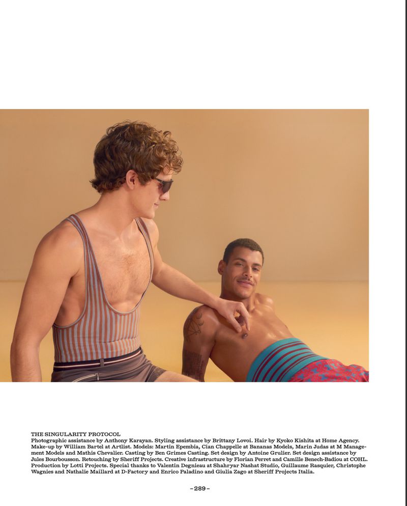 Two male models posing in vintage-style swimwear against a warm beige backdrop for Fantastic Man editorial.