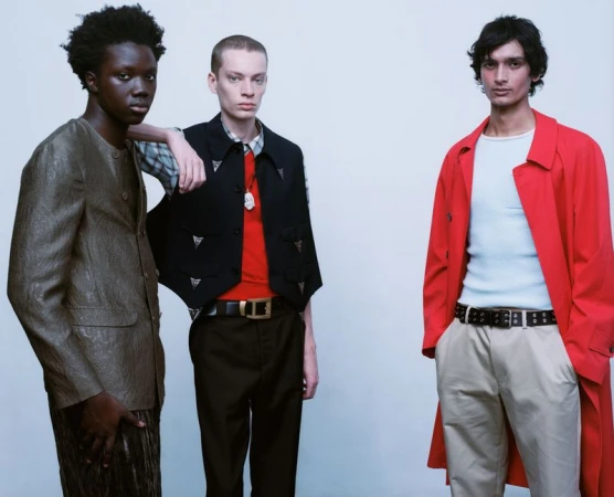 Three male models in styled menswear standing together against a pale studio backdrop for The Journeying.