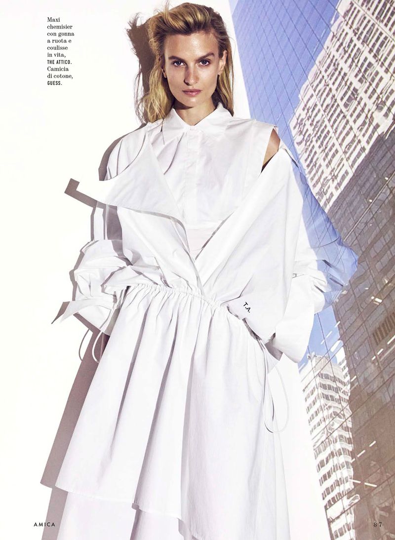 Model Veronika Vilim wearing an architectural white shirt dress layered over a collared shirt for Amica magazine editorial.