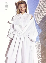 Model Veronika Vilim wearing an architectural white shirt dress layered over a collared shirt for Amica magazine editorial.