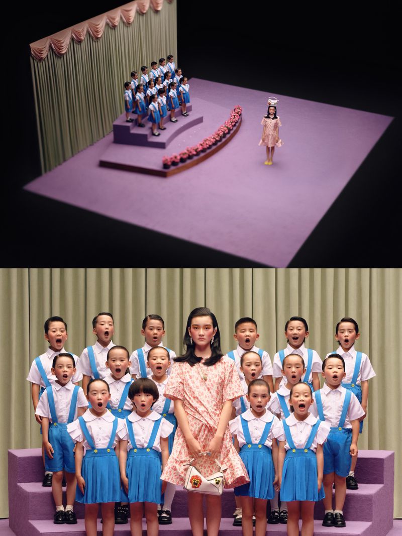 Model in a pink dress poses with a choir of young children in blue outfits on a purple stage with beige curtains in the background.