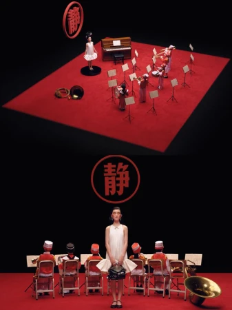 Fashion shot of a woman in a white dress holding a handbag, standing in front of musicians in orange suits against a dark backdrop.
