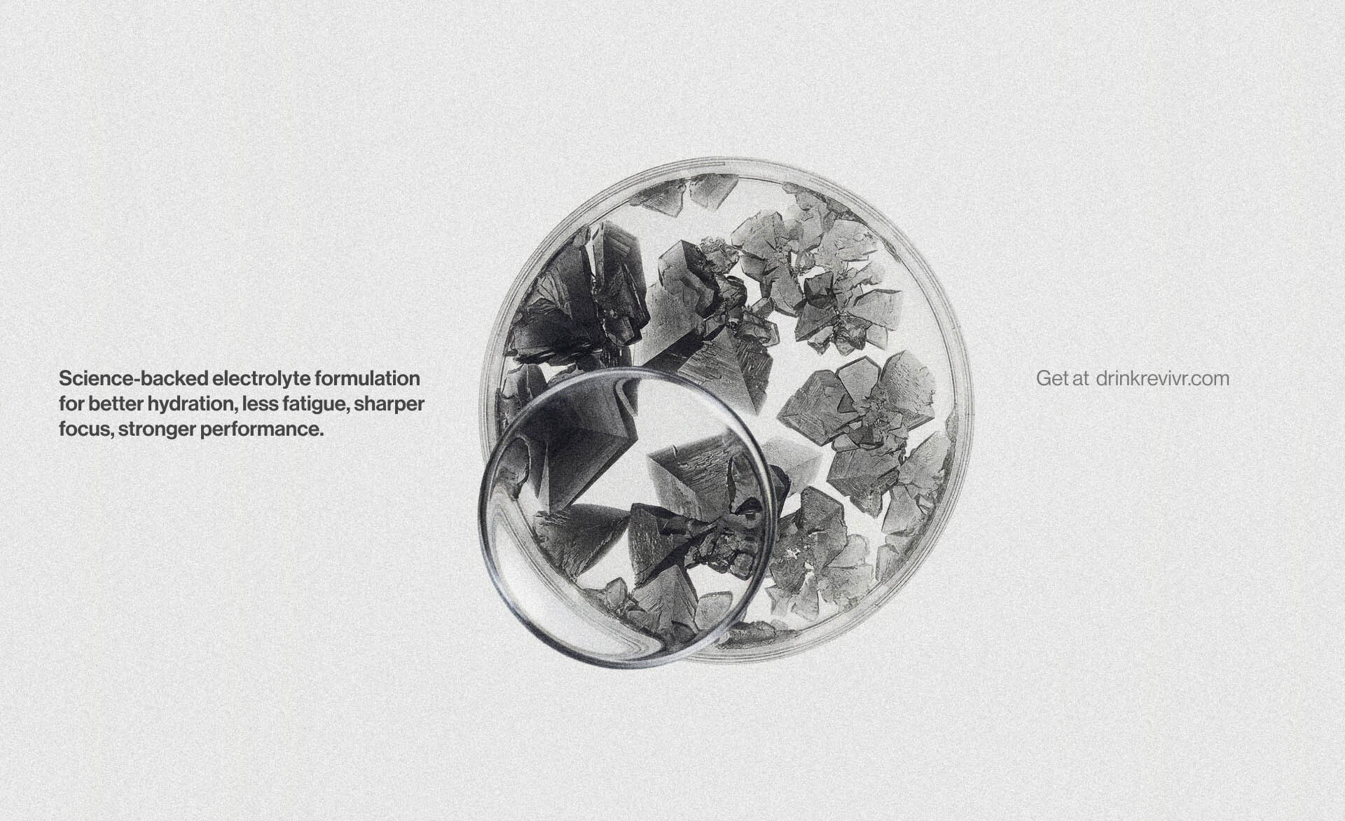 Microscopic view of electrolyte crystals in a circular petri dish with a magnifying lens overlay and minimalist branding text.